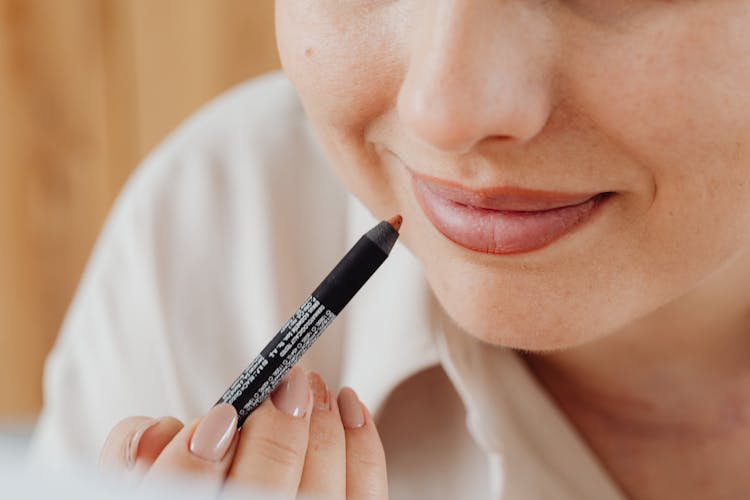 Woman Applying Lip Liner