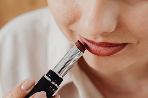 A Person Applying Red Lipstick