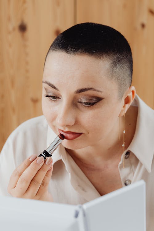 A Woman Applying Red Lipstick