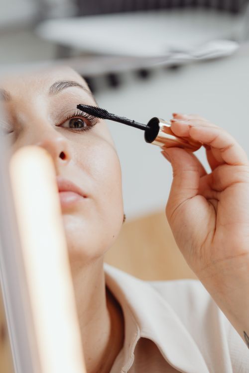 Free Close-up of a woman applying mascara, focusing on eye makeup detail. Stock Photo