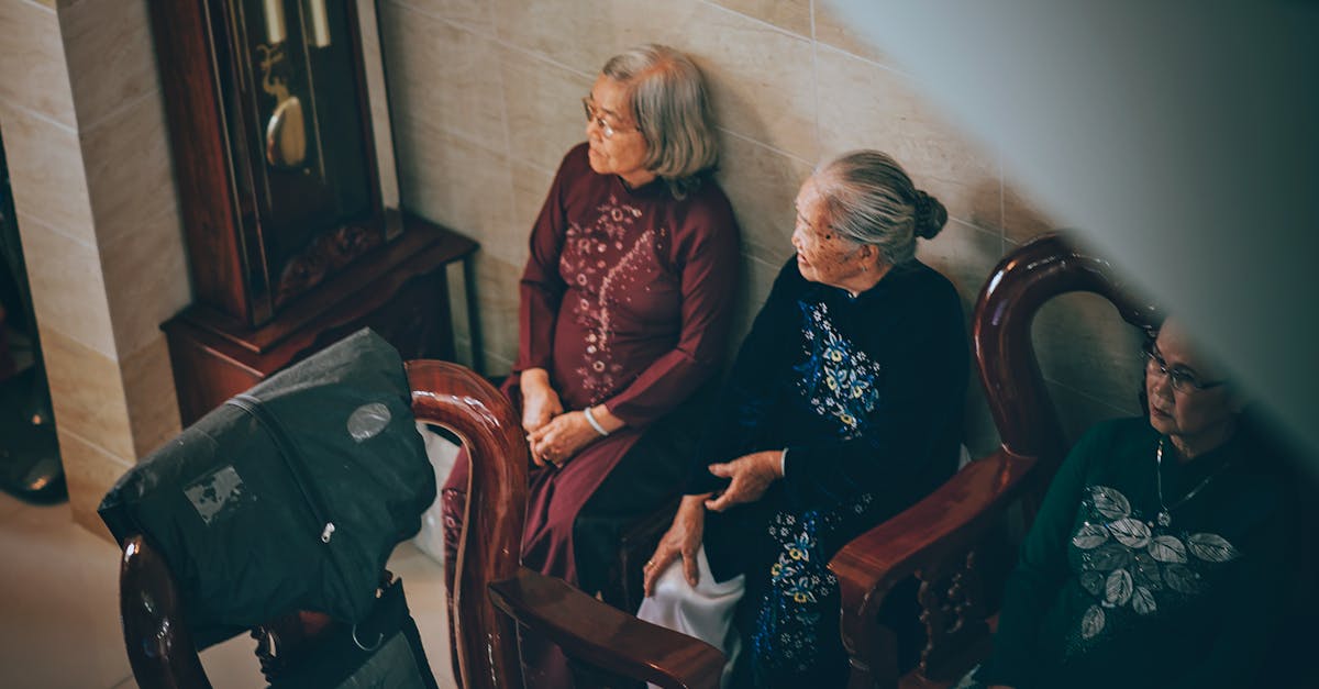 Three Old Women Sits on Bench Inside Room
