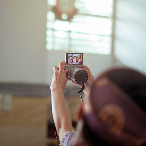 Person Holding Gray Dslr Camera