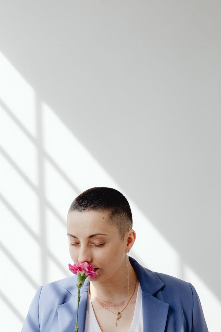 Portrait Of Woman Smelling Flower