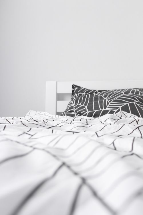 Free Stylish monochrome bedding in a modern minimalist bedroom setting, emphasizing simplicity. Stock Photo