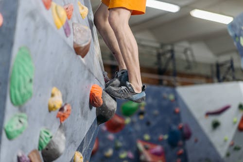 A Person Stepping on a Climbing Hold