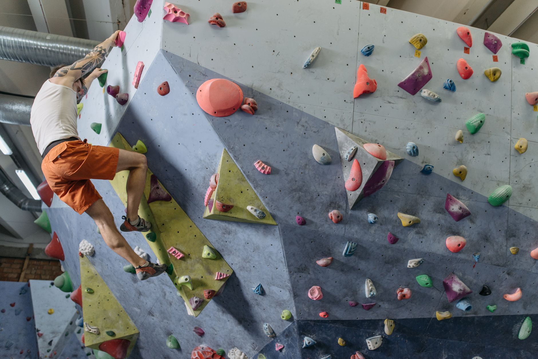 A man climbing an indoor rock wall