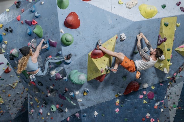 A Man And Woman Climbing On The Wall