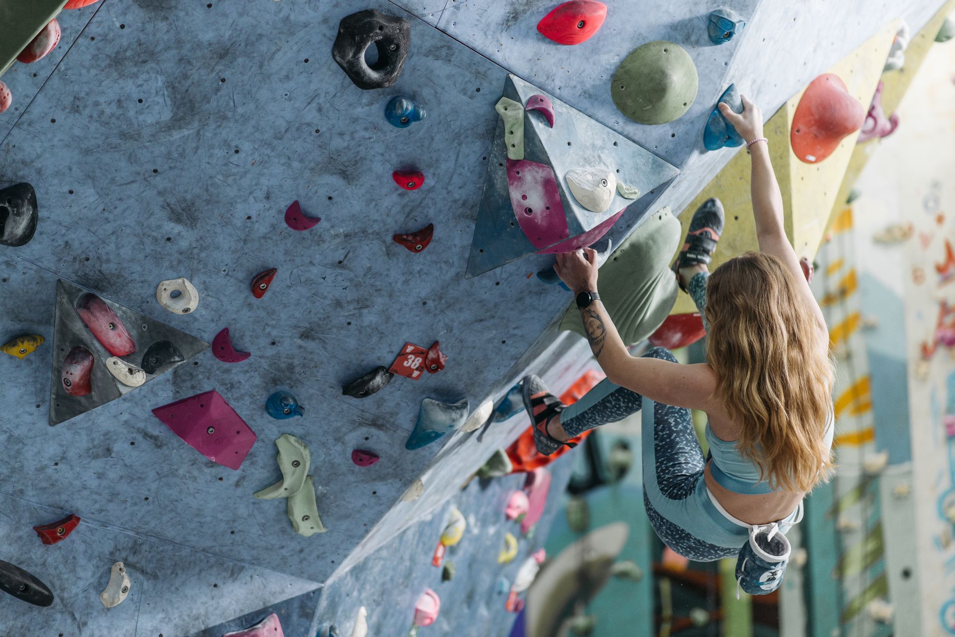 A Person in Activewear Climbing a Climbing Wall