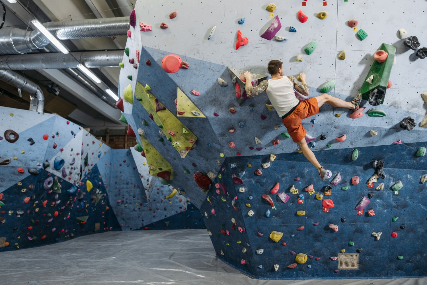 Climber on a bouldering wall at Ascent