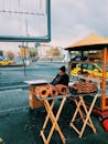 A Man Sitting Near Food Stall