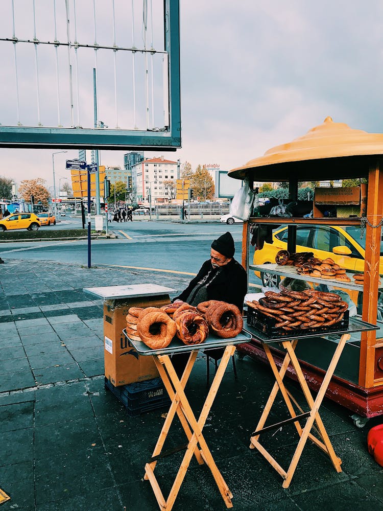 A Man Sitting Near Food Stall