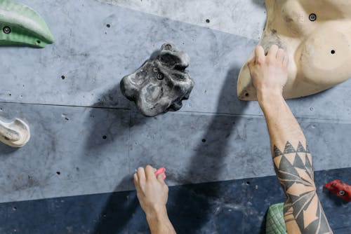 Close-up Shot of a Hand Climbing the Wall