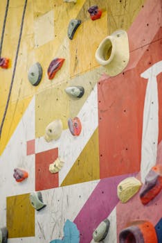 Close-up of a vibrant climbing wall with various holds, perfect for sports enthusiasts.