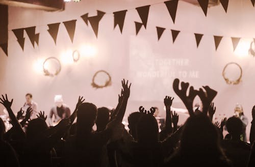 Free People Raising Hands in Watching a Concert Stock Photo