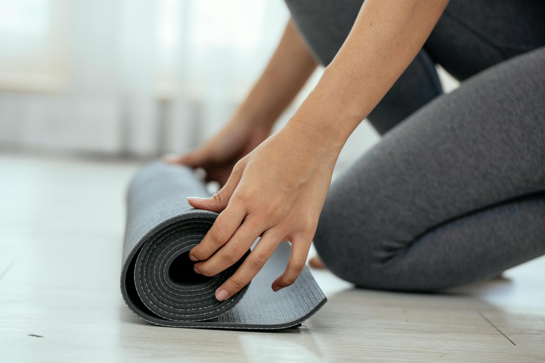 https://www.pexels.com/photo/crop-woman-unrolling-mat-in-daylight-7592343/