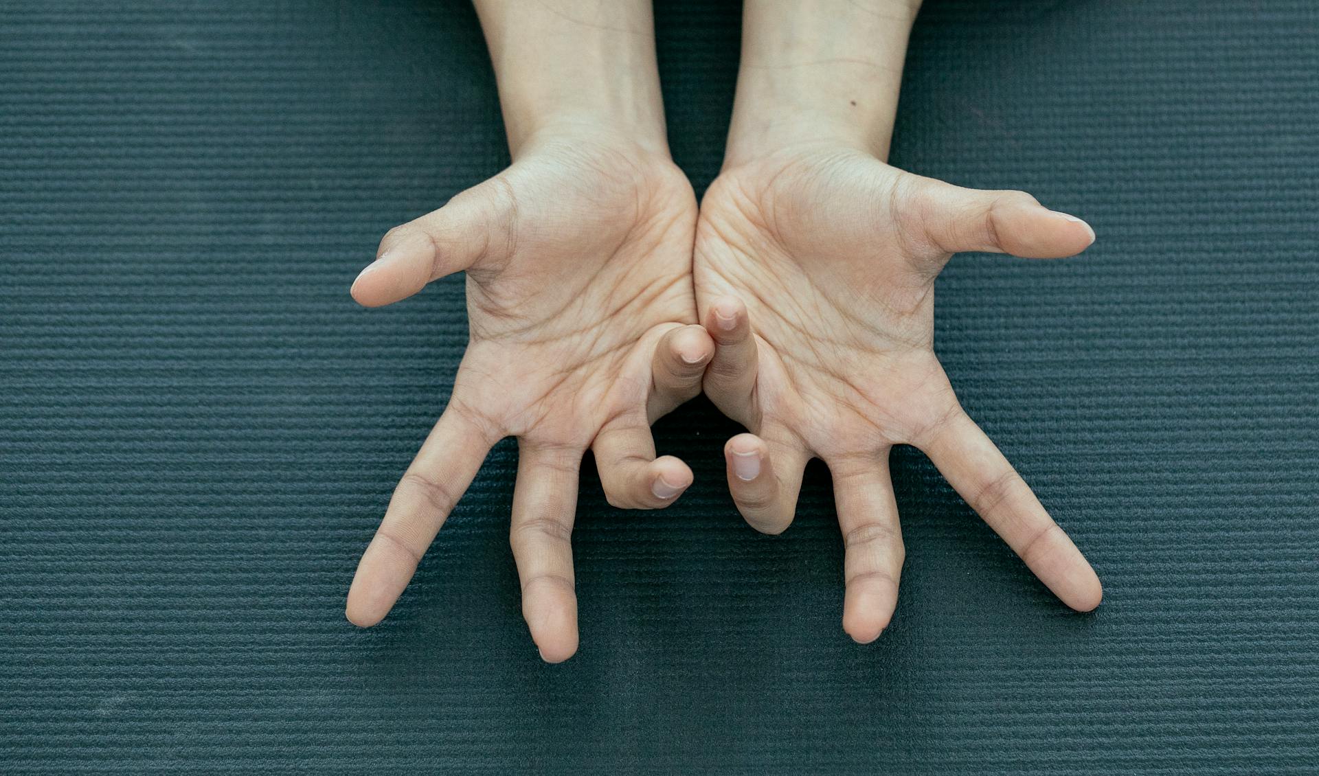 Crop person showing palms with curved fingers