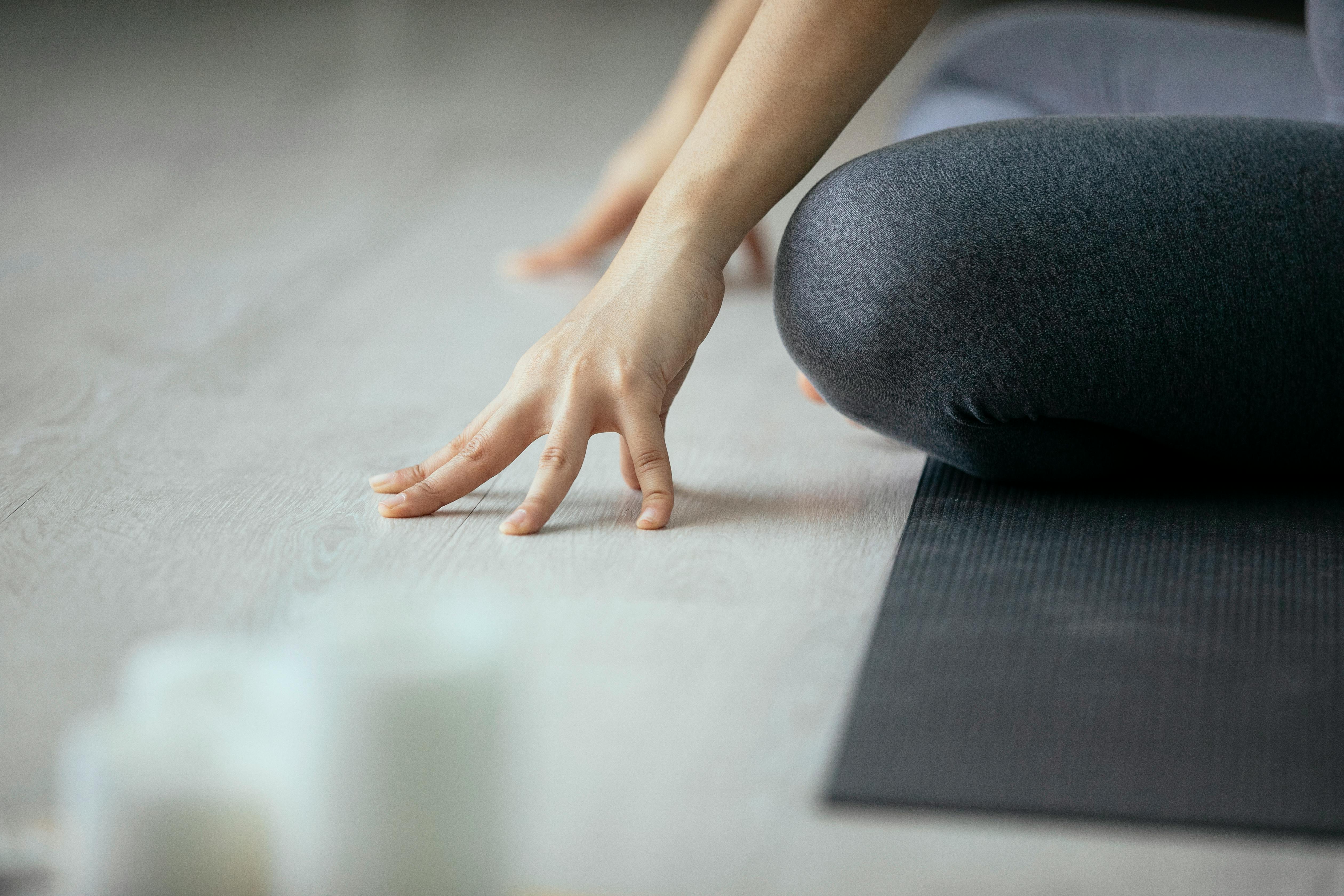 Back view of unrecognizable people performing Padmasana yoga pose