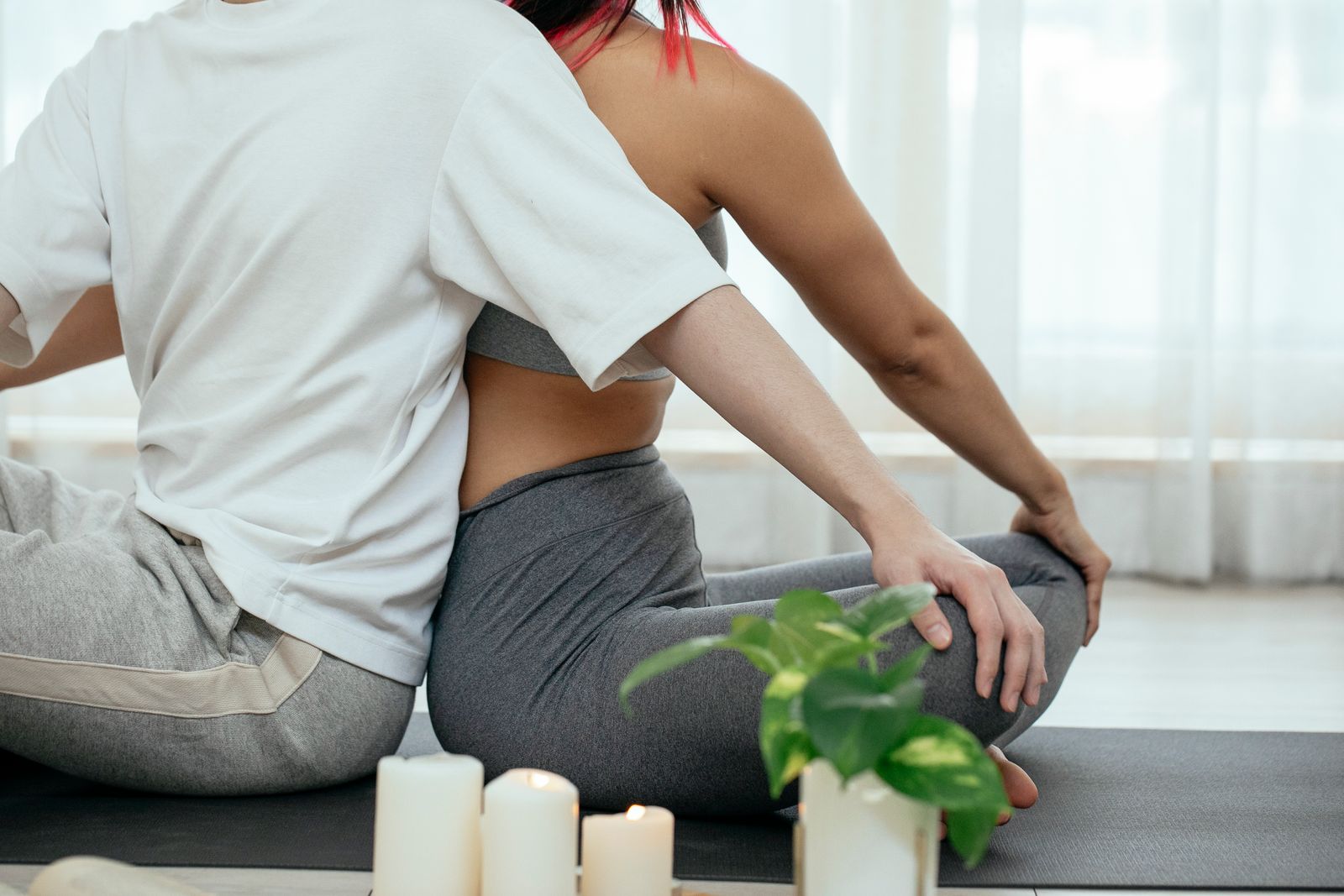 Bright home setting with a person holding their lower back and abdomen while moving carefully