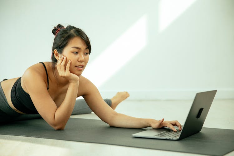 Asian Woman With Laptop On Floor