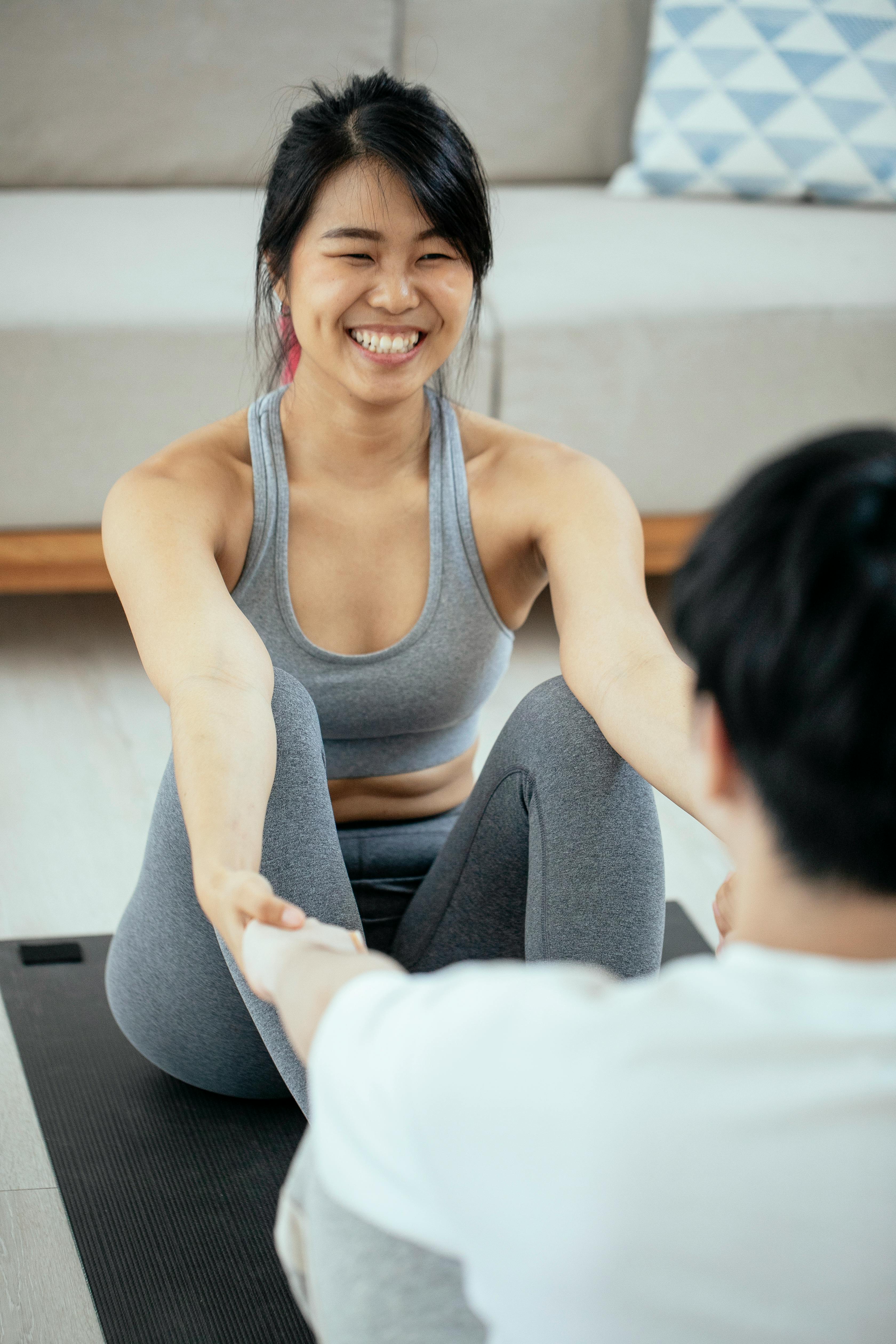 Young Asian Attractive Yoga Professional Instructor Helping A Student To  Strange Her Pose And Body Balance. Well Being Concept. Stock Photo, Picture  and Royalty Free Image. Image 142474764.