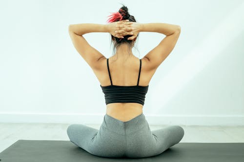 Woman Sitting on a Yoga Man