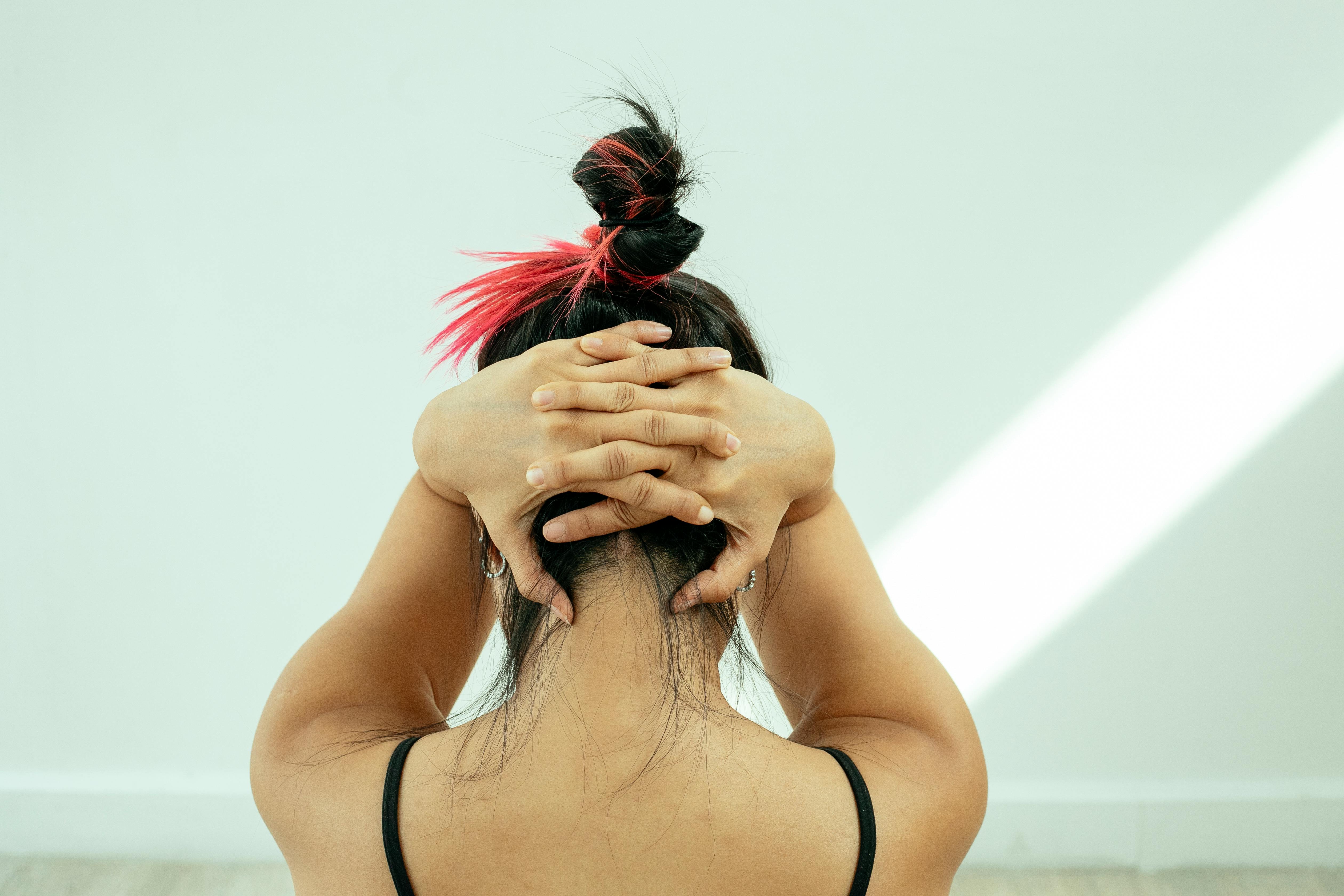 unrecognizable woman stretching neck