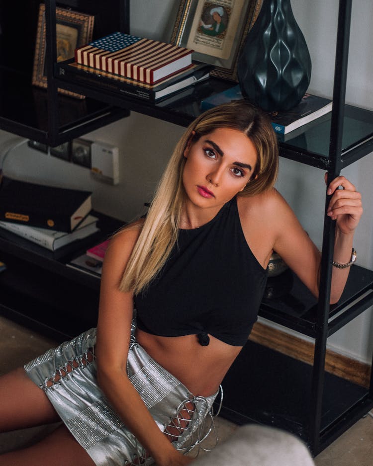 Portrait Of A Woman In A Tank Top And A Silver Mini Skirt