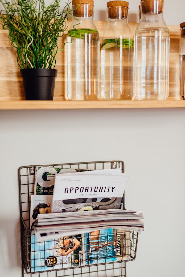 White and Black Magazine on Brown Wooden Shelf