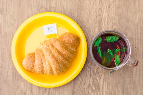 Free Top View of Tea and Croissant Bread on Wooden Surface  Stock Photo