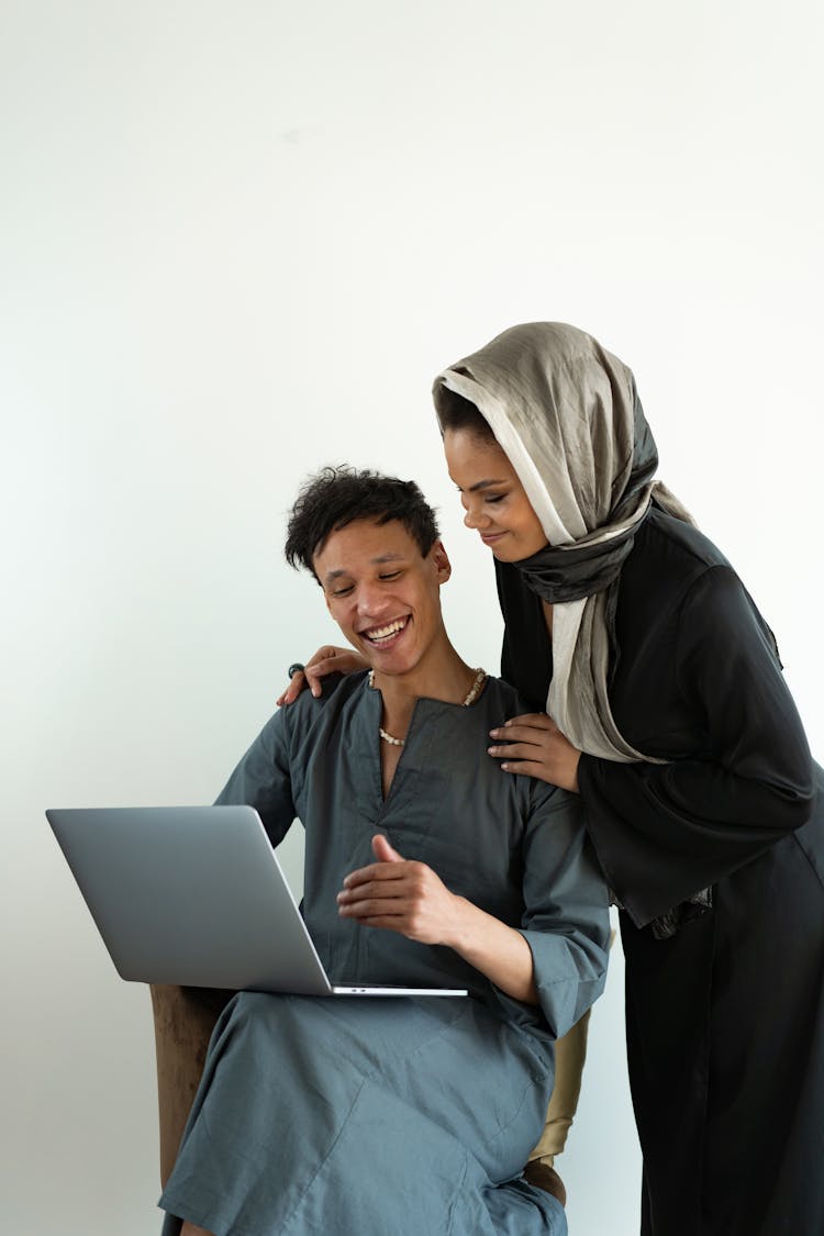 Man Looking At Laptop Beside Woman 