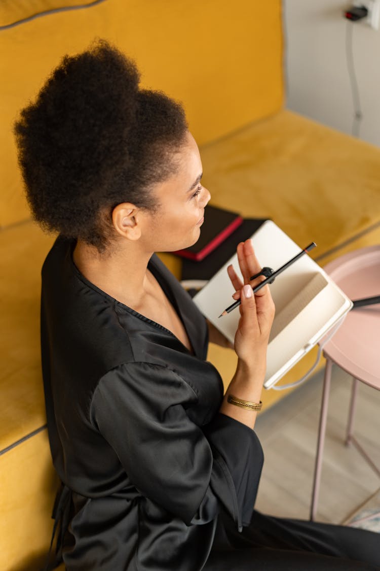 Woman Holding A Notebook And A Pencil