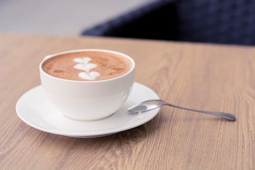 Free Photo of a Cup of Coffee on a White Saucer with a Metal Spoon Stock Photo