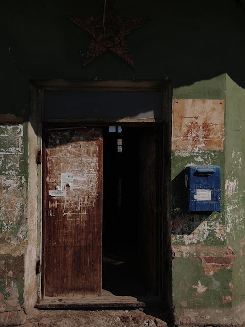 Opened door of old weathered building