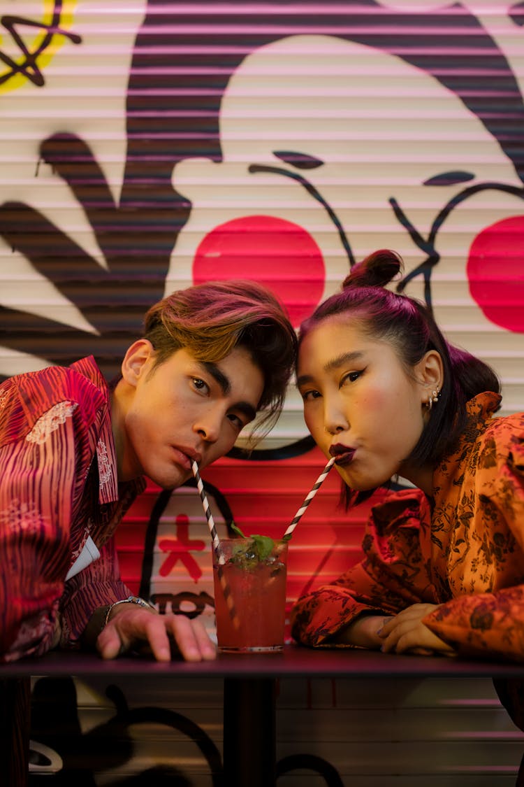 Couple Drinking From A Glass