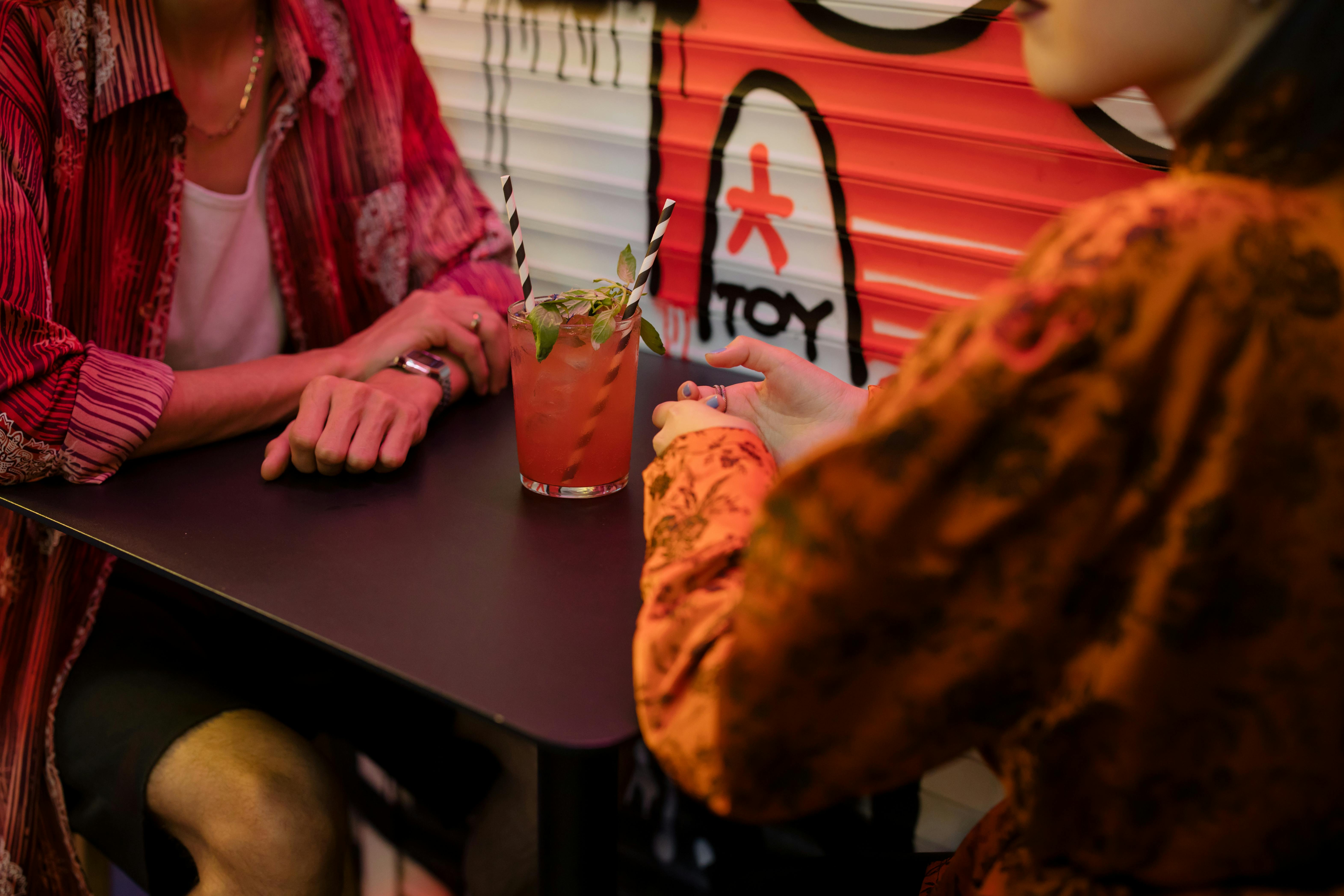 couple sharing a cocktail drink