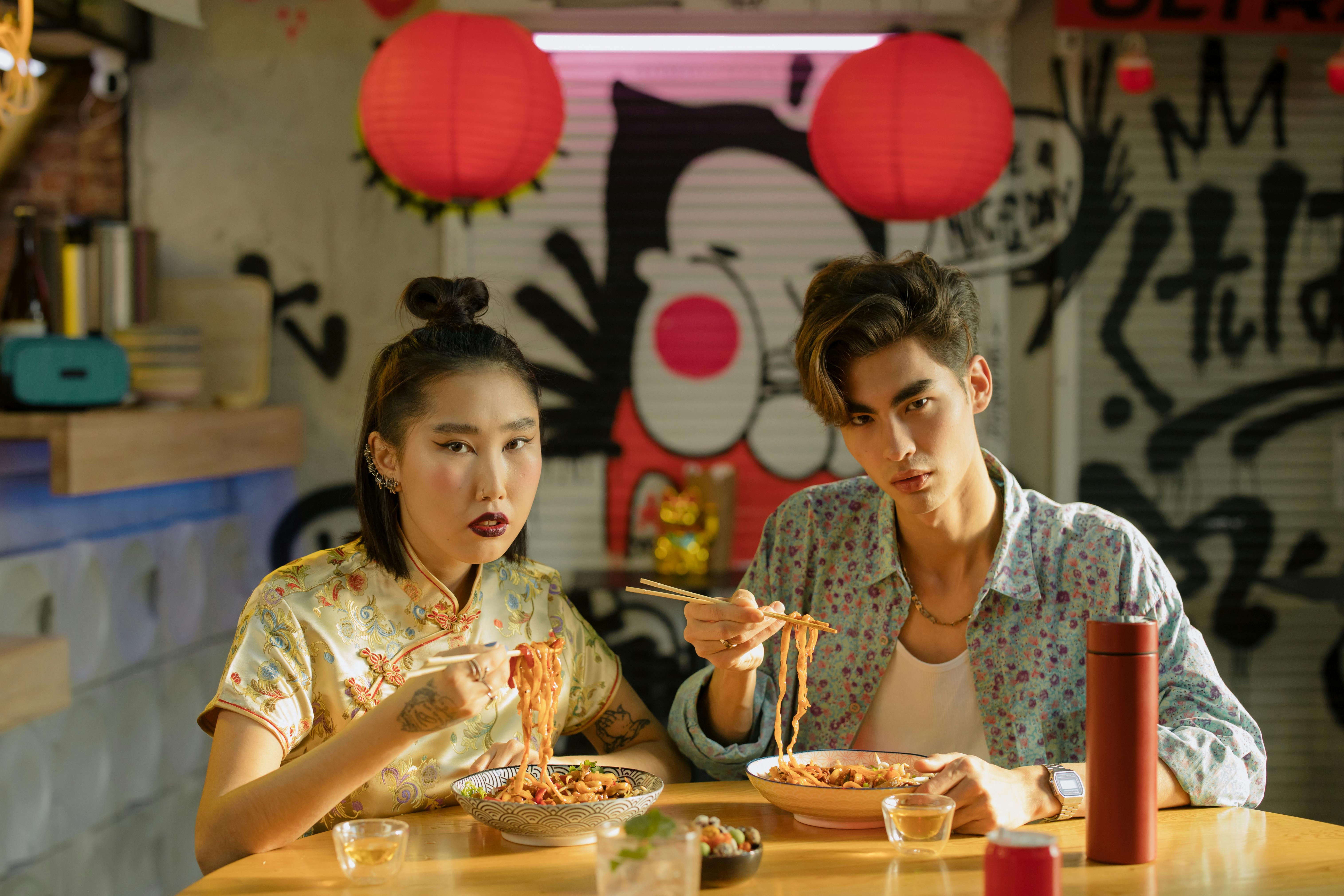 couple eating bowl of noodles