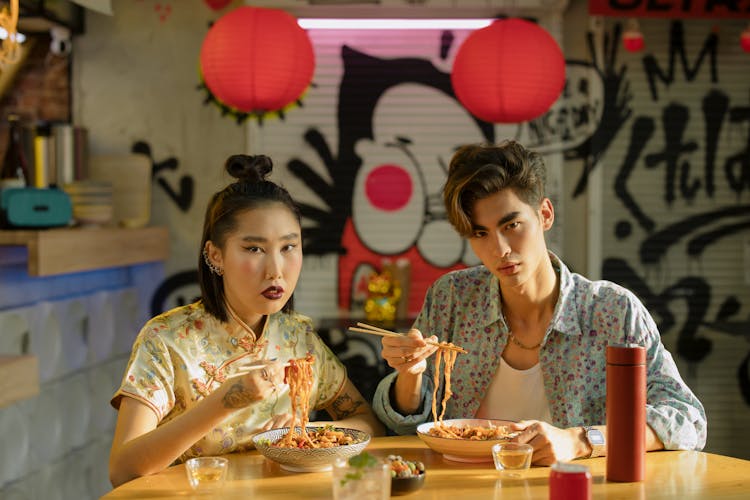 Couple Eating Bowl Of Noodles