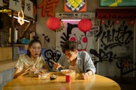 Couple Eating Bowl of Noodles