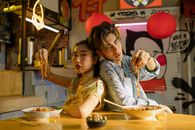Man and Woman Holding Noodles with their Hands