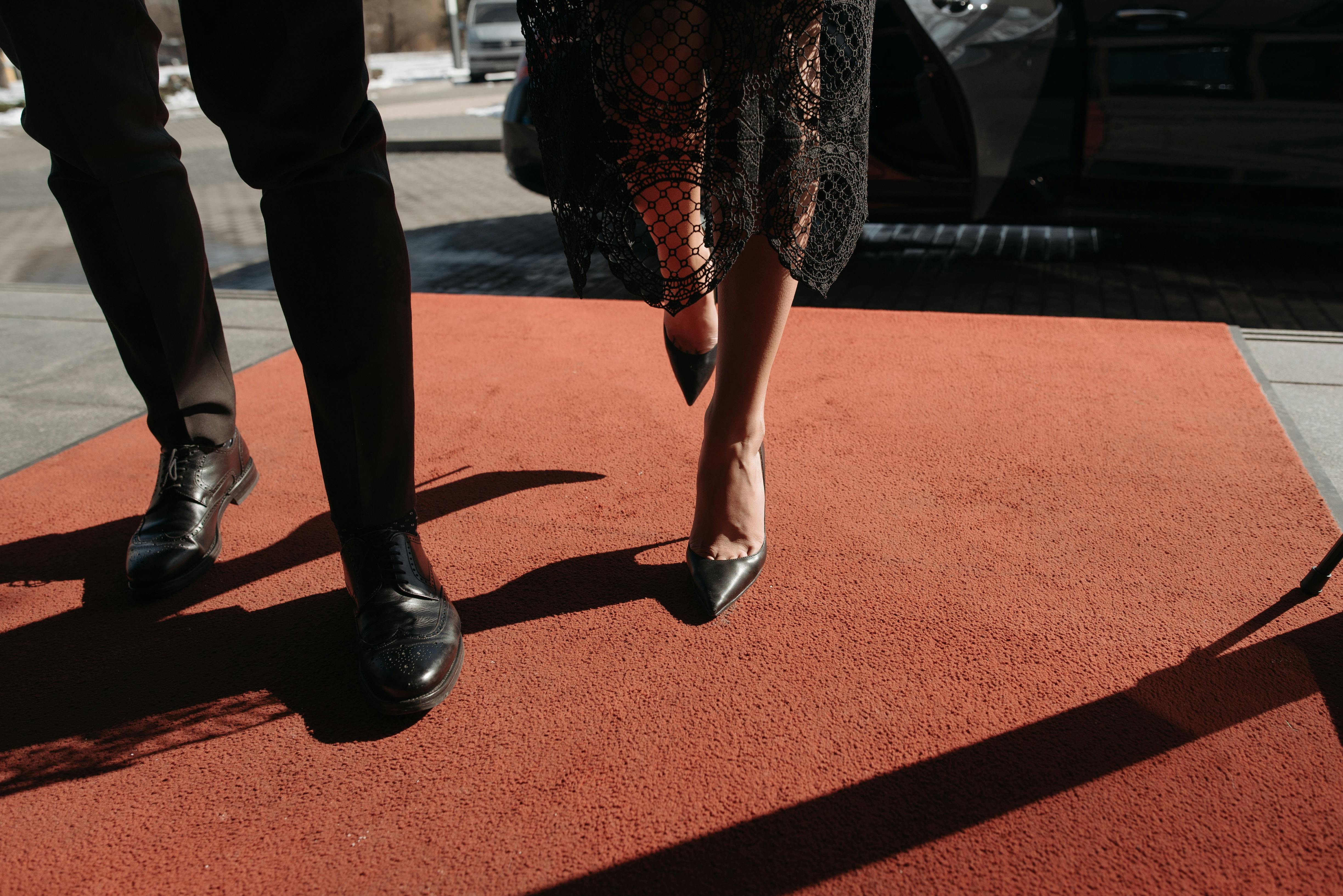 A Couple Standing on the Red Carpet