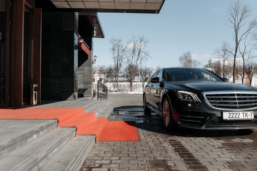 A Car Parked in Front of a Building Entrance