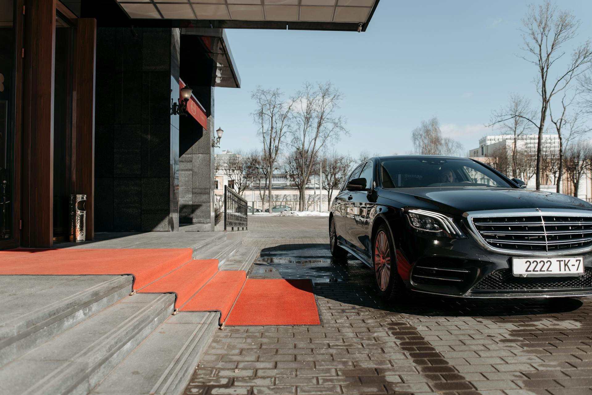 A Car Parked in Front of a Building Entrance