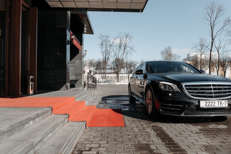 A Car Parked In Front Of A Building Entrance