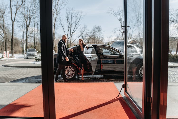 Man And Woman Going Out Of A Car 