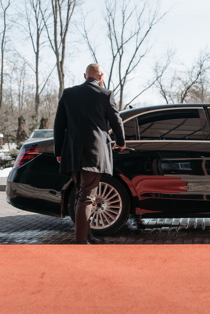New Class Limo chauffeur opening door for passenger