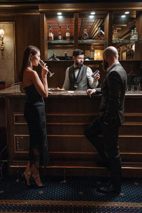 Customers Standing in Front of the Bar Counter