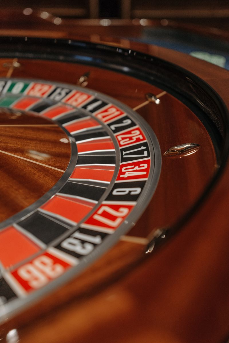 Detailed close-up of a wooden roulette wheel showing its numbers and pockets