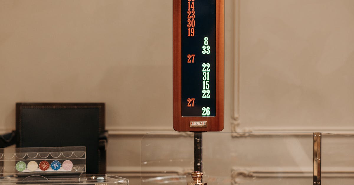 Photo by Pavel Danilyuk Elegant casino setup featuring a roulette wheel, colorful chips, and a scoreboard.