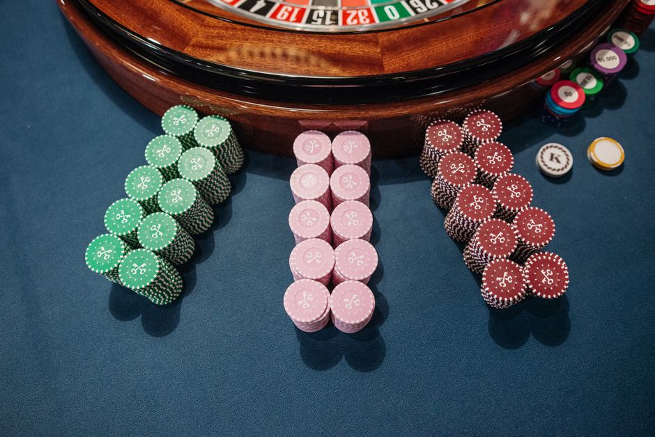 An overhead view of a roulette table with neatly stacked colorful poker chips, reflecting a casino vibe.