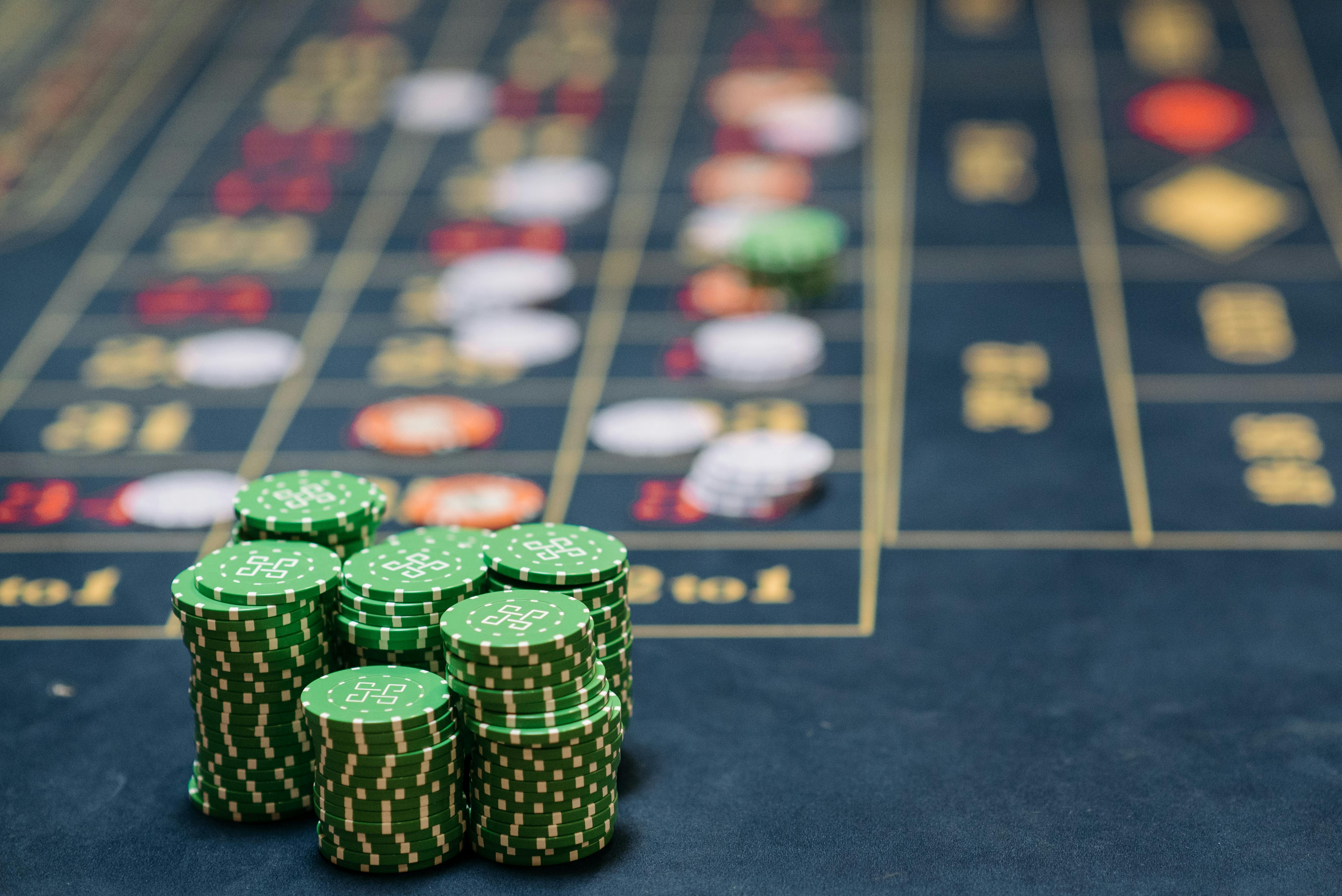 stacks of green colored gambling chips